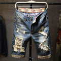 Distressed men's denim shorts with many holes