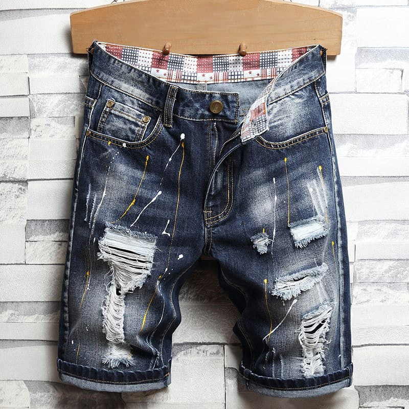 Distressed men's denim shorts with many holes