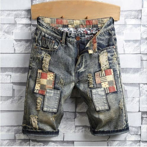 Distressed men's denim shorts with many holes