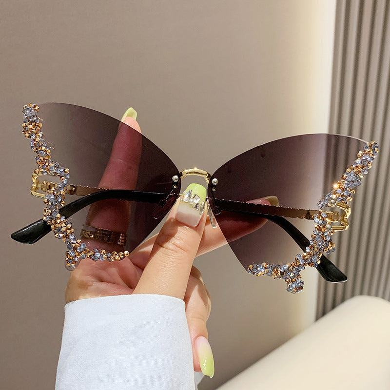 Butterfly-shaped sparkling rhinestone-rimmed sunglasses