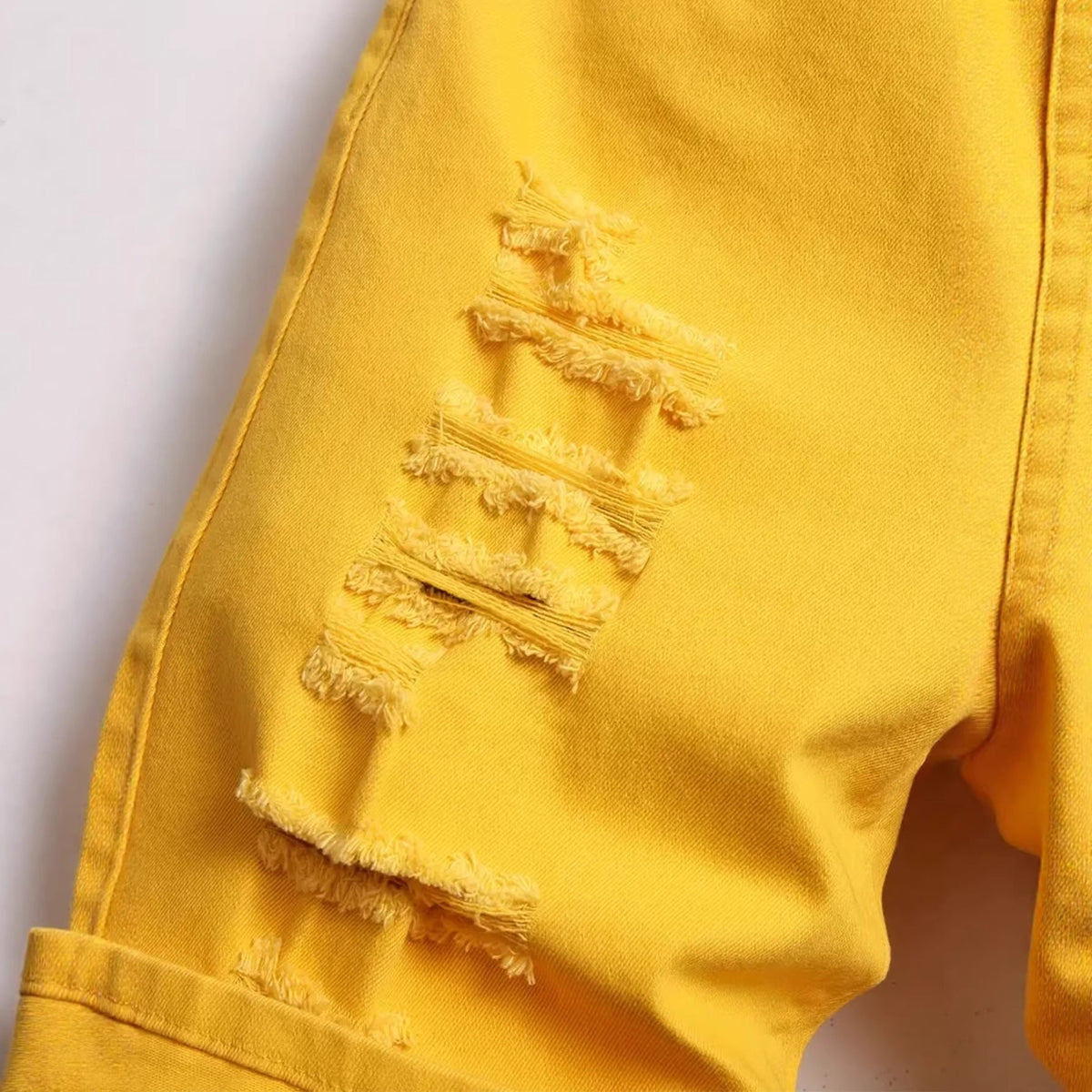 Men's ripped yellow stretch mid-length straight leg distressed denim shorts