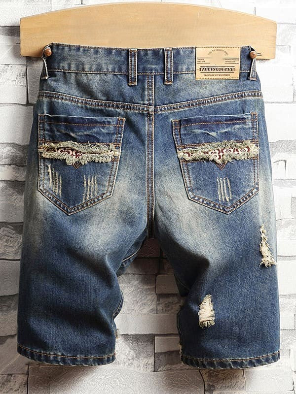 Distressed men's denim shorts with many holes